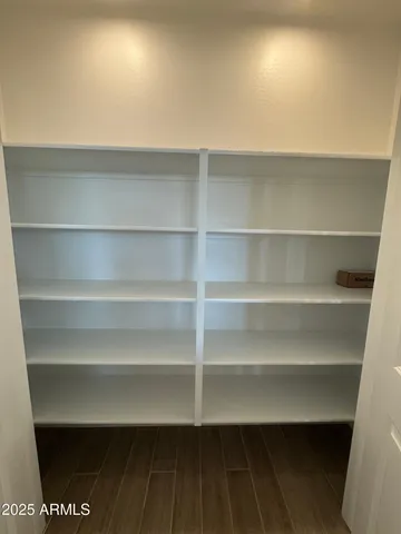 a view of walk in closet with empty racks