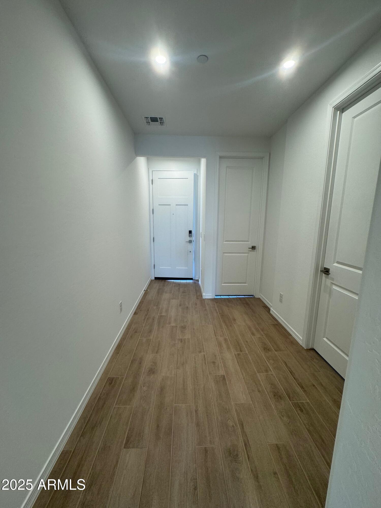 13351 West Eagle Feather Road Peoria, AZ 85383 - Photo 2 of 23 an empty room with wooden floor and windows