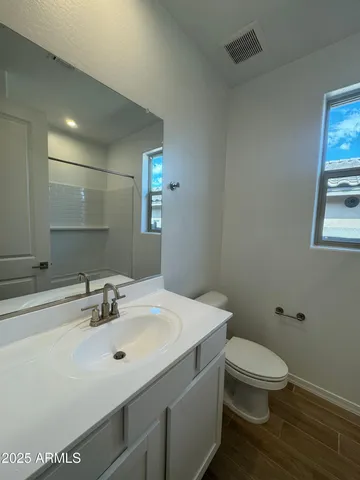 a bathroom with a sink toilet and mirror