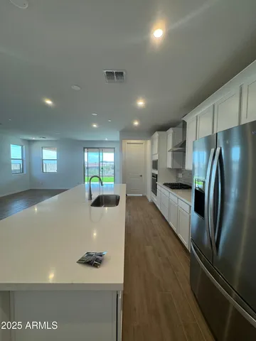 a kitchen with stainless steel appliances a refrigerator sink and stove