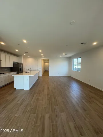 a view of kitchen and hall with wooden floor and kitchen