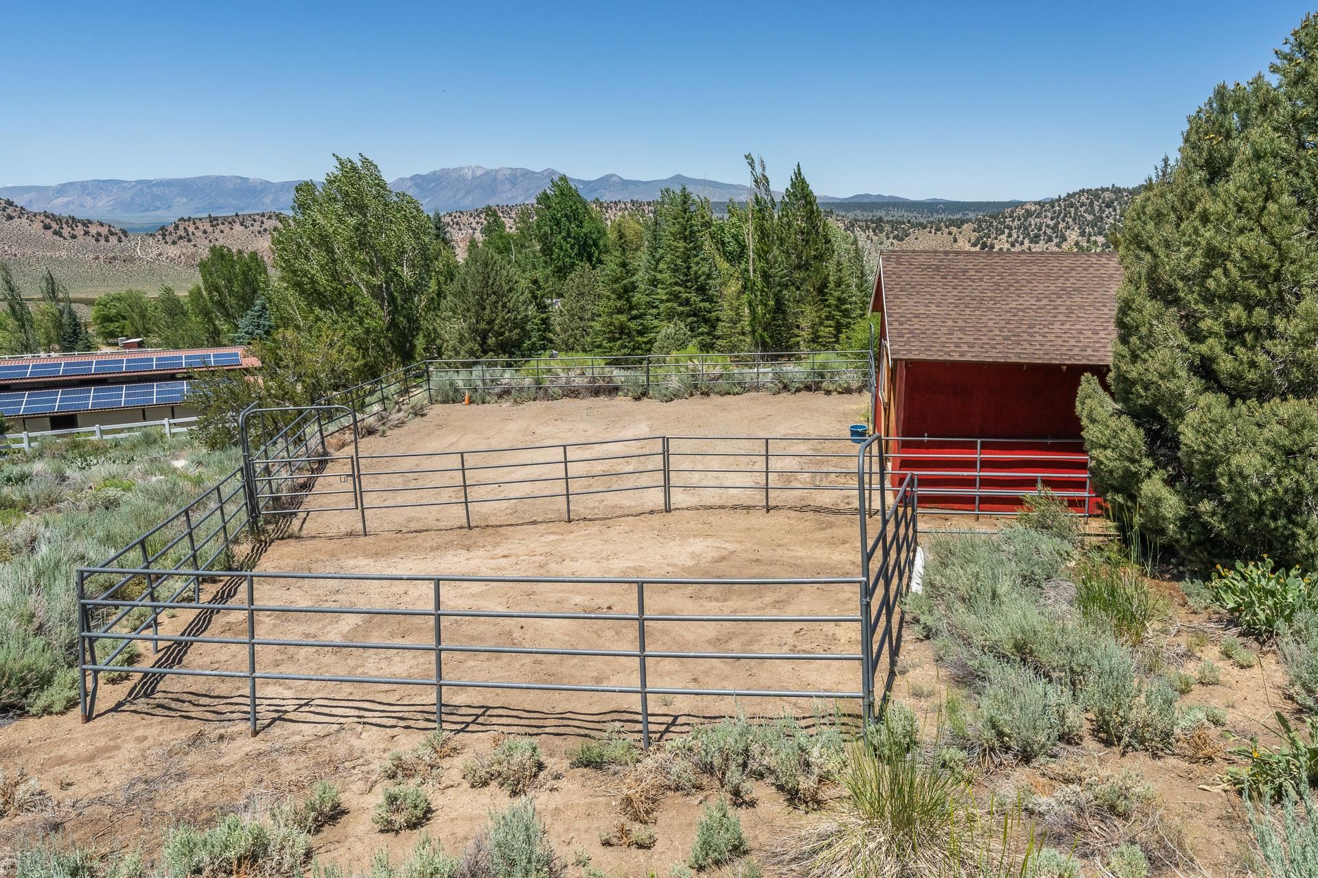 537 Aspen Spring Ranch Road Mammoth Lakes, CA 93546 - Photo 30 of 40 Fenced corral system with a red barn featuring a shingle roof