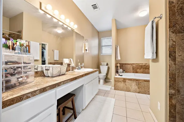 a bathroom with a tub and a walk in closet