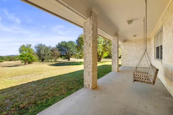 a large bathroom with a granite countertop double vanity sink a bathtub and next to a window