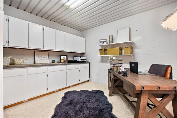 a workspace with furniture and book shelf