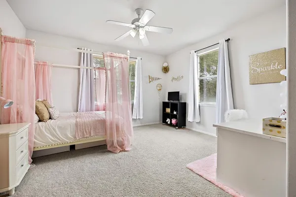 a room with pool table and windows