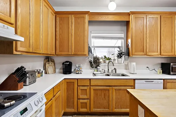 a kitchen with stainless steel appliances granite countertop a sink counter space and cabinets
