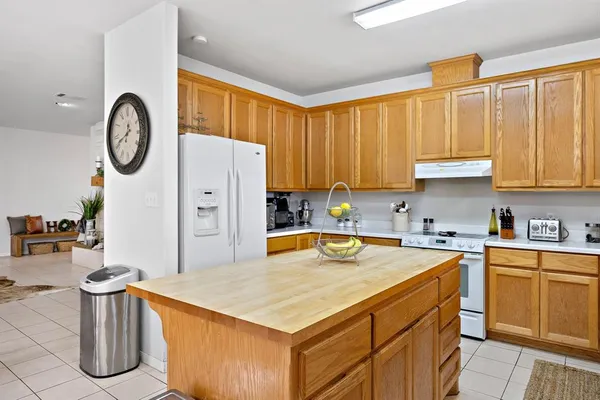 a kitchen with stainless steel appliances granite countertop a sink a stove and cabinets