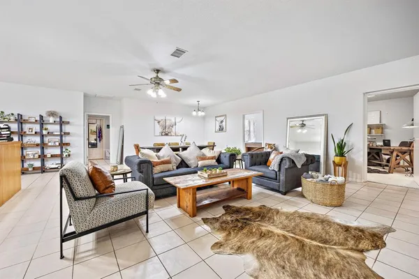 a view of a dining room with furniture and chandelier