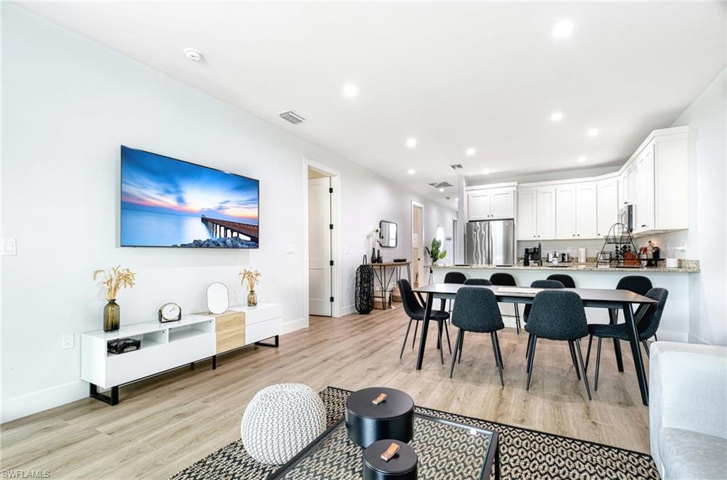 a view of a dining room with furniture and wooden floor