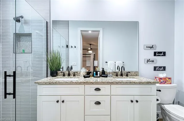 a bathroom with a double vanity sink mirror and double