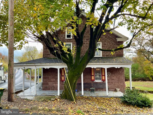 front view of a house with a tree