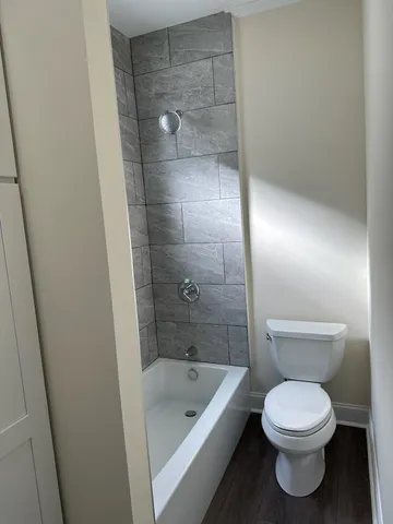 a bathroom with a toilet and a shower