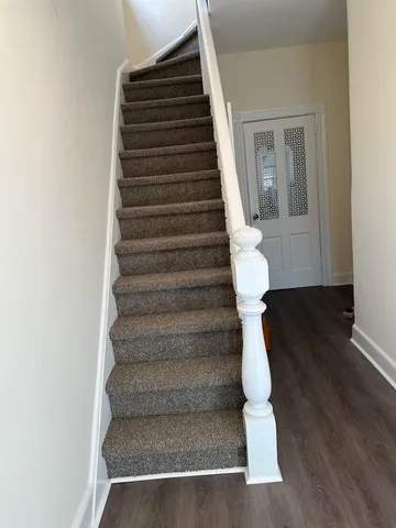 a view of entryway and hall with wooden floor
