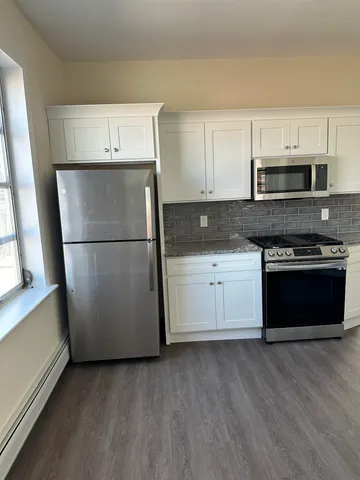 a kitchen with a refrigerator and a stove