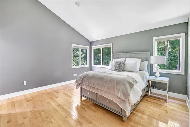 a large bed sitting in a bedroom next to a window