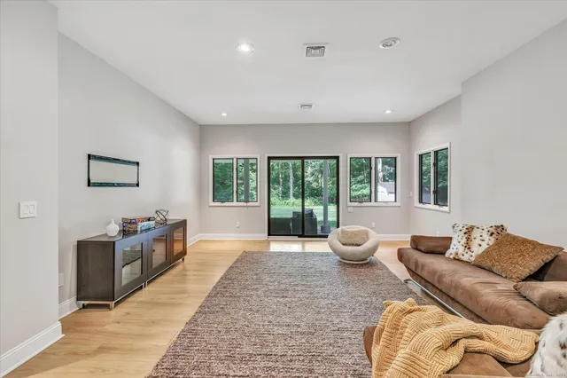 a living room with furniture and floor to ceiling window