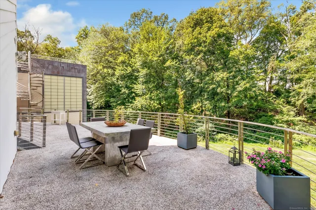 a view of a chairs and table in the backyard