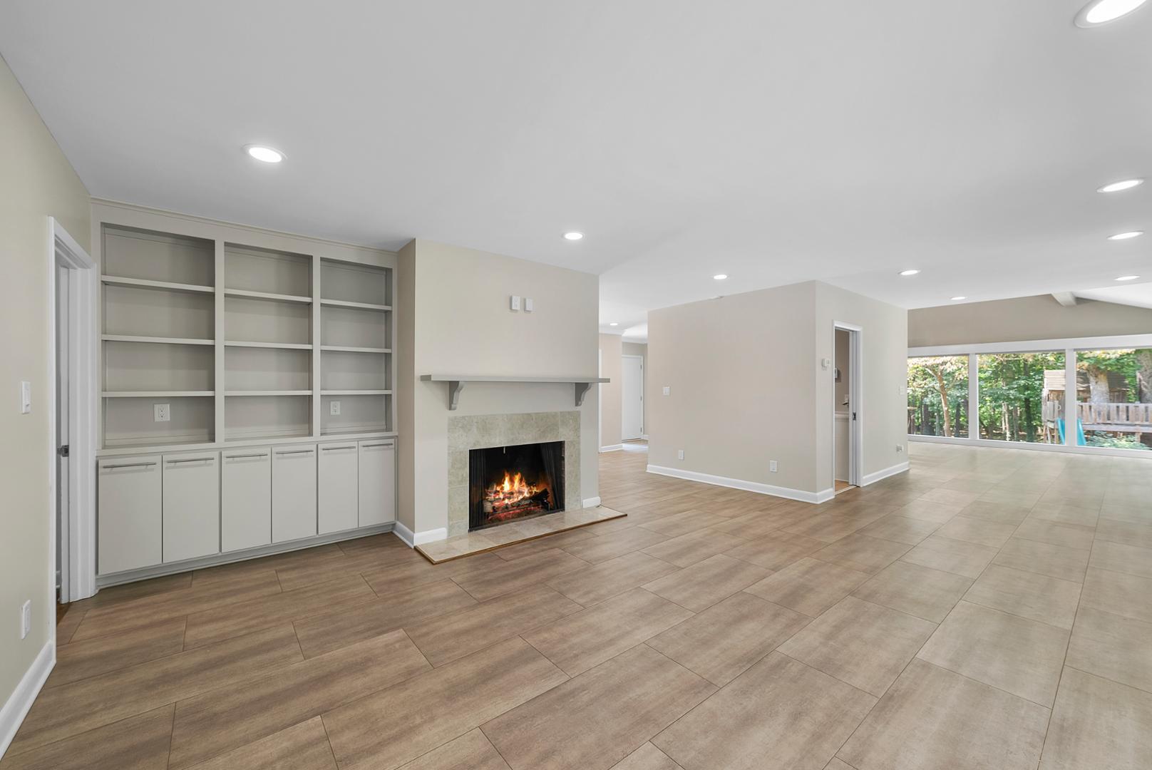 1605 Ridge Road Raleigh, NC 27607 - Photo 11 of 36 a view of an empty room with a fireplace and a window