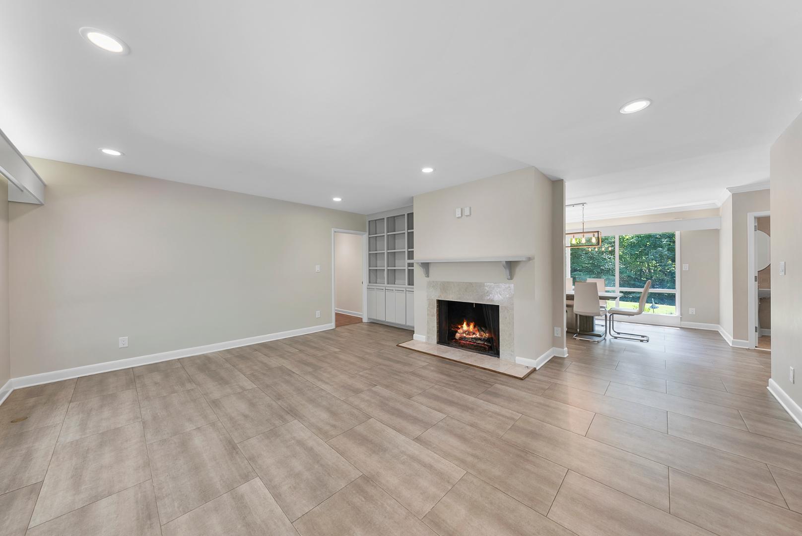 1605 Ridge Road Raleigh, NC 27607 - Photo 12 of 36 a view of empty room with wooden floor fireplace and windows
