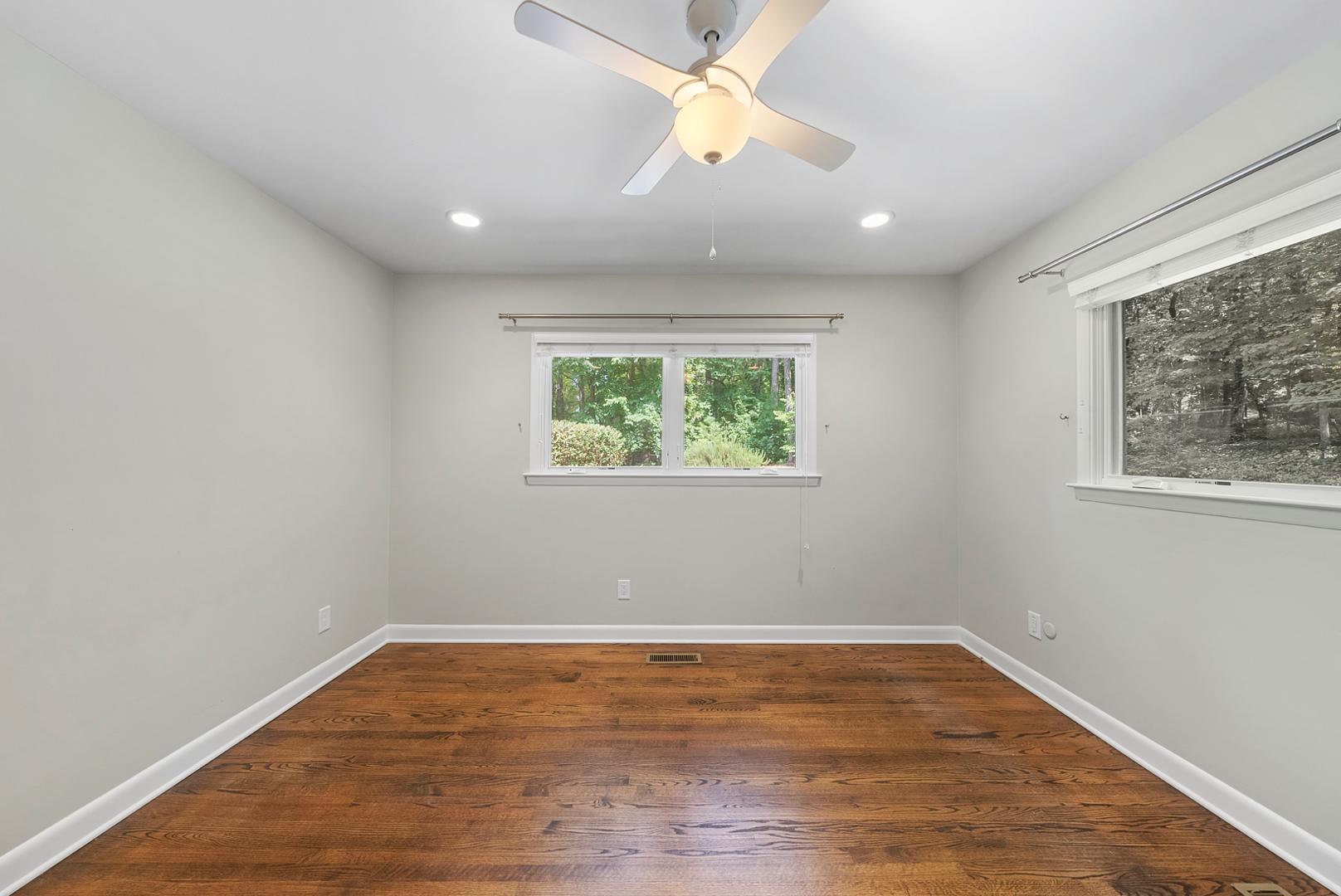 1605 Ridge Road Raleigh, NC 27607 - Photo 17 of 36 an empty room with wooden floor and window