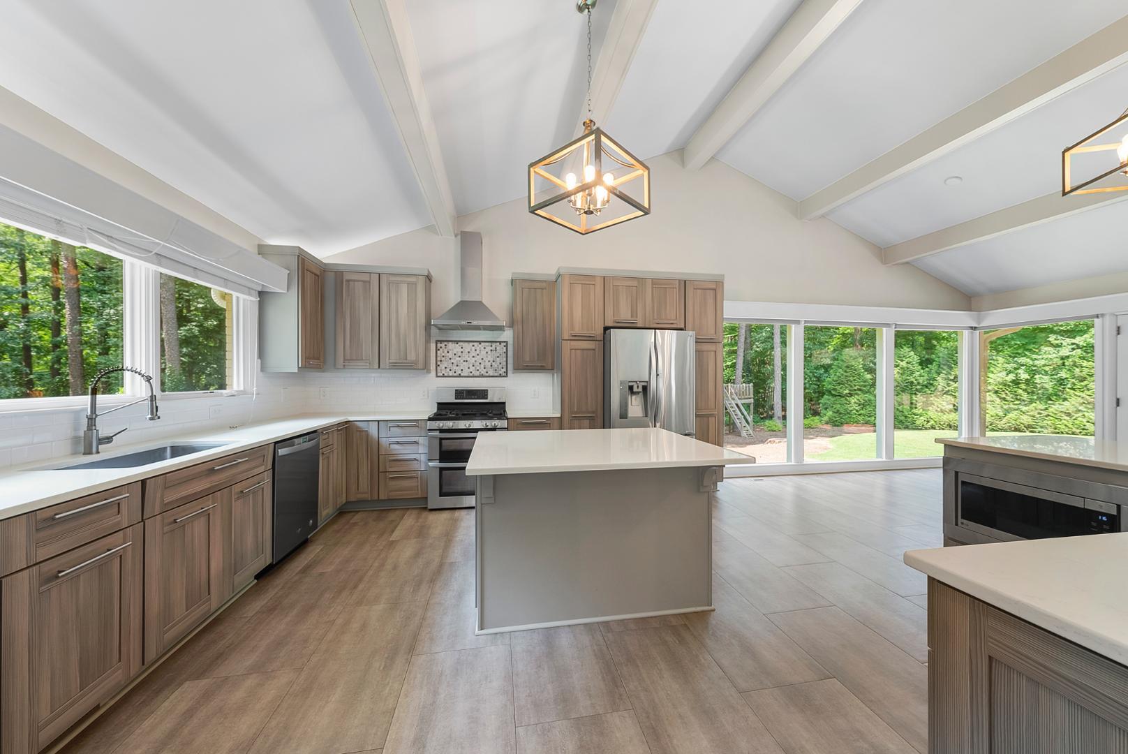 1605 Ridge Road Raleigh, NC 27607 - Photo 2 of 36 a large kitchen with a large window a sink stainless steel appliances and cabinets