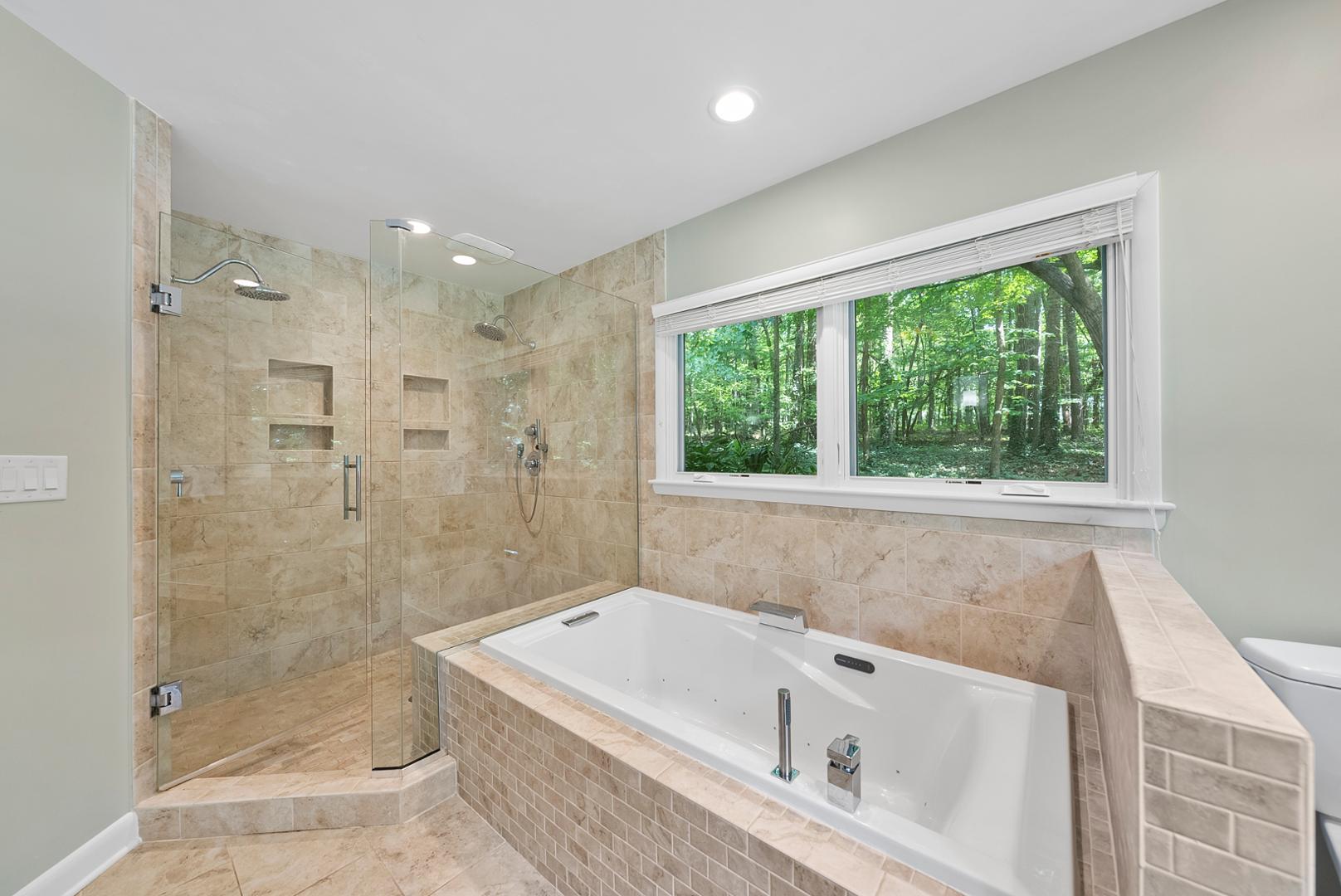 1605 Ridge Road Raleigh, NC 27607 - Photo 24 of 36 a bathroom with a bathtub a shower and a window
