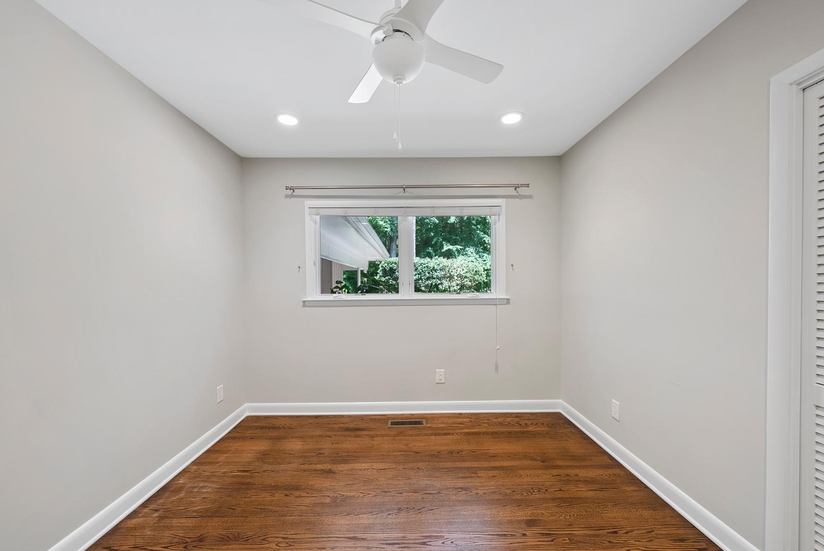 1605 Ridge Road Raleigh, NC 27607 - Photo 25 of 36 an empty room with wooden floor and windows