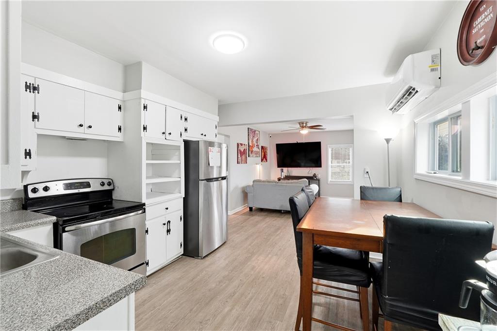 7 Willingham Street Rome, GA 30161 - Photo 13 of 25 a kitchen with stainless steel appliances a stove sink microwave and cabinets