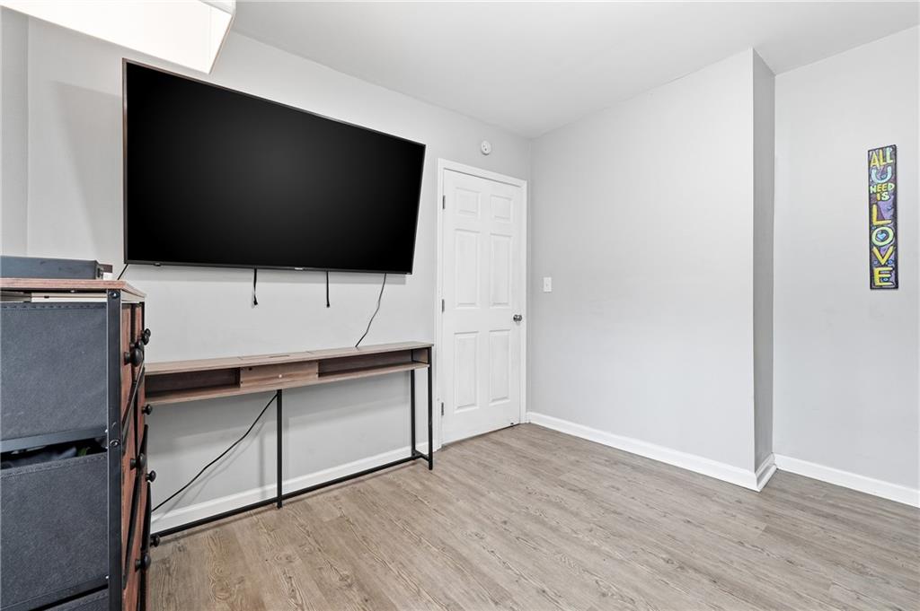 7 Willingham Street Rome, GA 30161 - Photo 19 of 25 a living room with a flat screen tv a rug and wooden floor