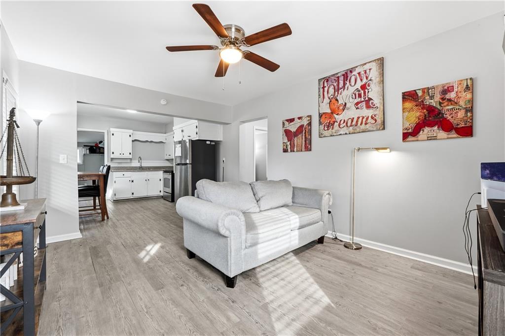 7 Willingham Street Rome, GA 30161 - Photo 7 of 25 a living room with stainless steel appliances furniture a flat screen tv and a refrigerator