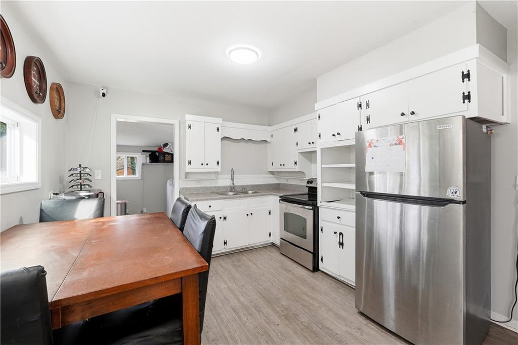 7 Willingham Street Rome, GA 30161 - Photo 10 of 25 a kitchen with white cabinets and stainless steel appliances