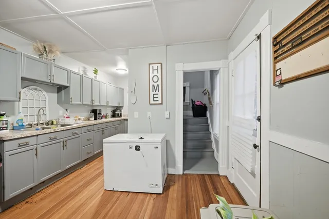a kitchen with cabinets and wooden floor