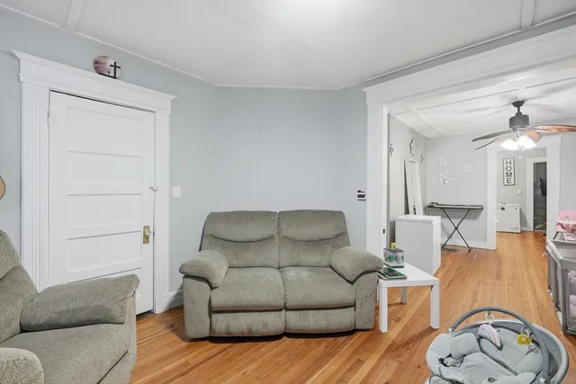 a living room with furniture a couch and a potted plant