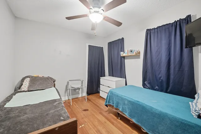 a bedroom with a bed and a chair