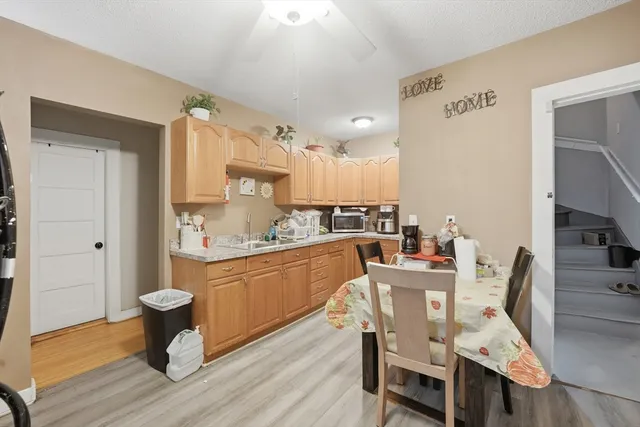 a kitchen with granite countertop white cabinets and stainless steel appliances