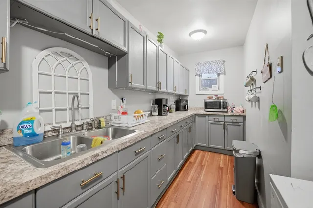 a kitchen with stainless steel appliances granite countertop a sink a stove and cabinets