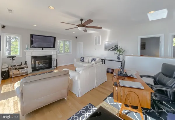 a spacious bedroom with a bed and a lamp