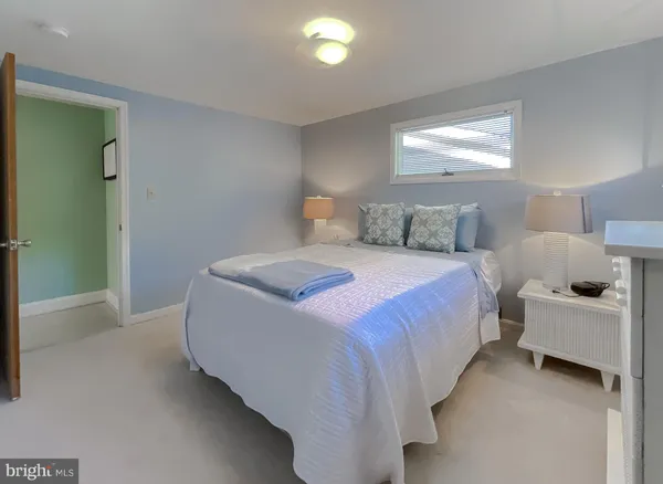 a kitchen with stainless steel appliances kitchen island granite countertop a refrigerator a stove a microwave oven a dining table and chairs with wooden floor
