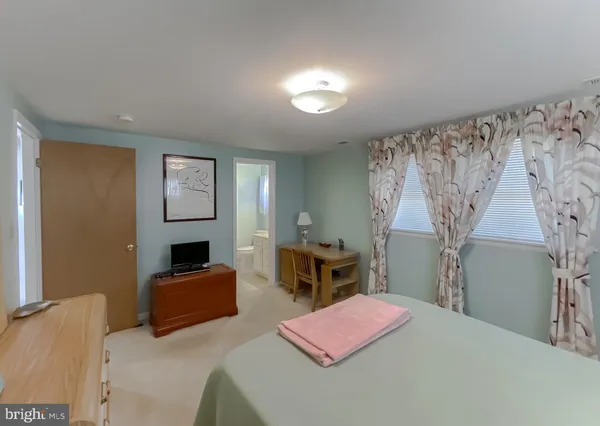 a kitchen with stainless steel appliances granite countertop a dining table and chairs
