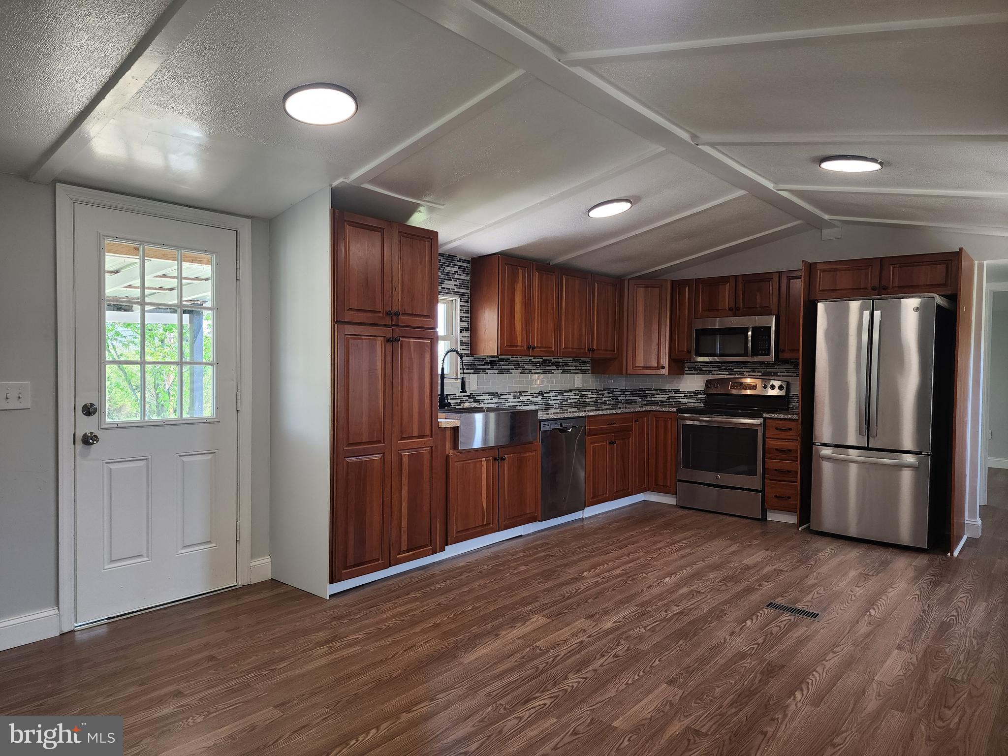41 Mountain View Terrace Newville, PA 17241 - Photo 8 of 34 a kitchen with stainless steel appliances granite countertop a refrigerator microwave and wooden floor