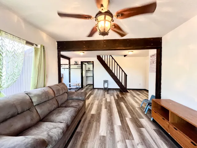 a living room with furniture and a chandelier