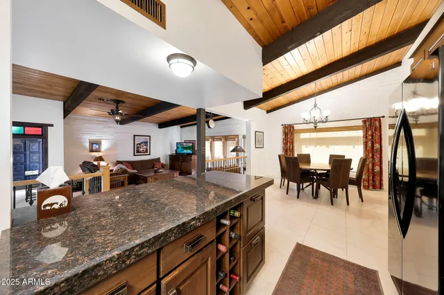a kitchen with stainless steel appliances granite countertop a sink a stove and cabinets