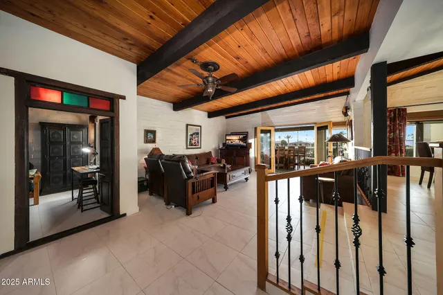 a living room with furniture a wooden floor and next to a window