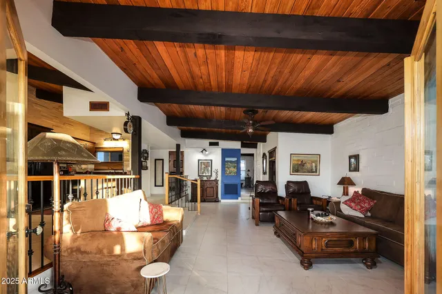 a bedroom with a bed a dresser and potted plants