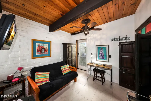 a living room with furniture and a painting on the wall