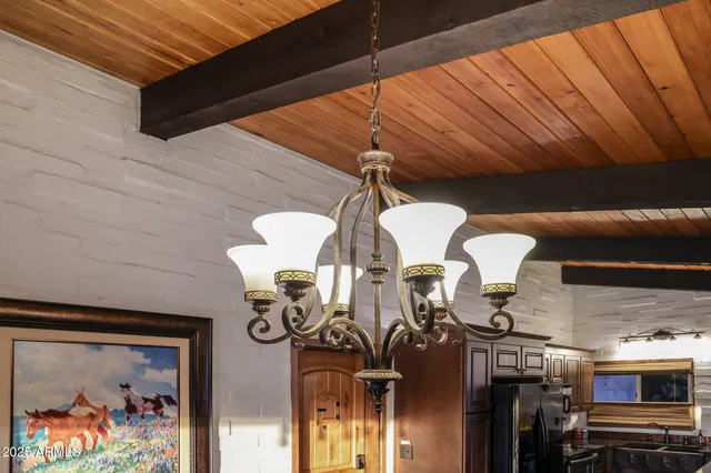 a view of a patio with table and chairs couches with wooden floor and fence