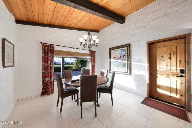 a view of a dining room with furniture wooden floor and chandelier