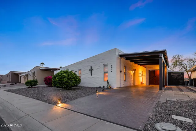 a kitchen with stainless steel appliances granite countertop a sink and a refrigerator