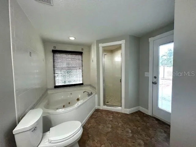 a bathroom with a toilet sink a mirror and bathtub